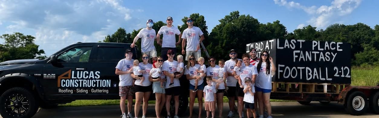 The Lucas Construction team and their families with the company truck at the Wentzville 4th of July Parade, 2025